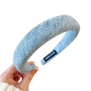 Light blue knitted headband for women with high crown effect and handmade fabric texture