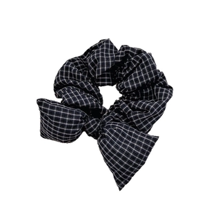 Minimalist black and white plaid bow hair scrunchie with classic grid pattern on white back