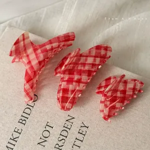 Set of three red plaid pattern hair claw clips in large, medium and small sizes