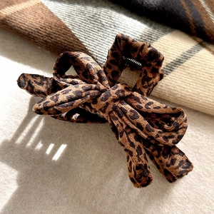 Leopard print bow hair claw clip with velvet texture and metal shark clip structure