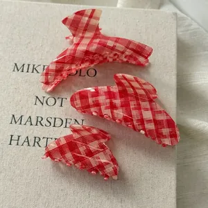 Three-piece set of red and white checkered hair claws with a vintage acetate finish