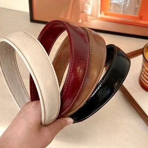 Set of four vintage faux leather padded headbands in white, red, brown, and black