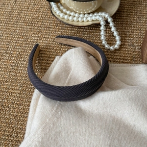 Detailed view of dark grey twill fabric headband with soft non-slip brown lining