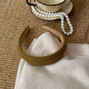 Detail of olive green twill fabric headband with soft non-slip lining and rich texture