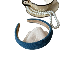 Blue knit texture headband with beige suede lining for a retro high-top hair look
