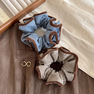 Retro striped scrunchies with fuzzy brown trim in blue and brown patterns