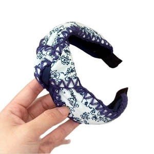 Bohemian floral wide headband with blue hand-crochet edges and twist knot design