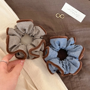 Retro striped scrunchies with plush edges in brown and blue colors, stylish hair ties