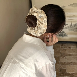 Bohemian paisley print scrunchie with lace edge and pearl details on model