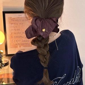 Elegant deep purple PU leather heart hair scrunchie shown on a ponytail for women