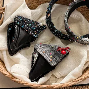 Elegant tweed hair accessories set with pearls and bows in a woven basket