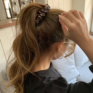 Classic leopard print scrunchie for women shown on high ponytail hairstyle for casual look
