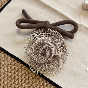 Gros plan détaillé d'un chouchou fleur en tricot avec texture de maille crème douce