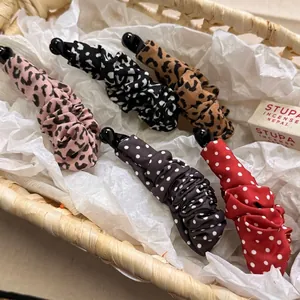 Banana hair clips set with leopard and polka dot patterns in a woven basket