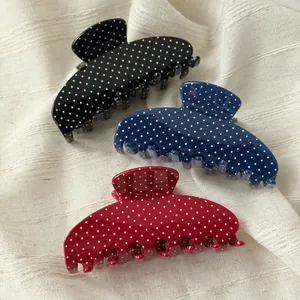 Vintage polka dot acetate shark hair clips in black, blue, and red for women