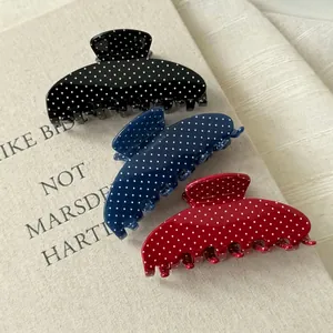 Three-piece set of retro polka dot acetate hair claws in black, navy blue, and bright red
