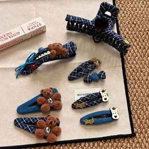 Navy blue plaid hair clip set featuring plush brown bear and winter aesthetic hair accessories