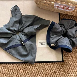 Grey and blue contrast fabric scrunchie with buttons and a stylish handmade ribbon bow