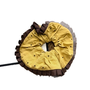 Yellow polka dot scrunchie with brown ruffled trim and elegant floral design