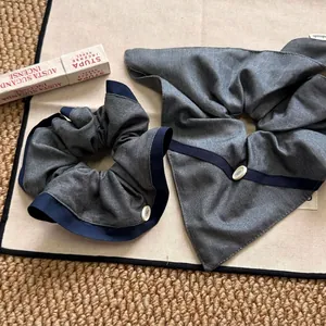 Gray and blue patchwork fabric scrunchie set with white buttons and handmade label