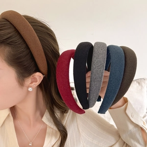 Detailed view of thick sponge headbands showing diverse colors and wool fabric textures