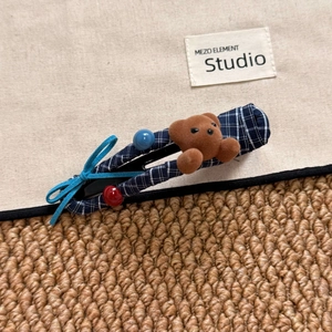 Detail of navy blue plaid BB hair clip with plush bear and blue ribbon bow decor