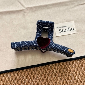 Detail of navy plaid hair claw clip with red velvet heart and gold metal wish label