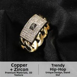 Macro view of a 14K gold plated Cuban link ring with zircon paved rectangular S plate