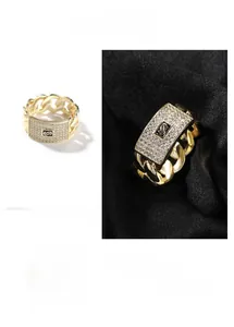 Macro detail of gold Cuban link ring featuring a rectangle pave zircon set and S logo