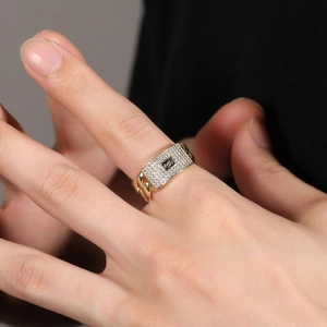 Detail of 14K gold Cuban chain ring featuring micro-paved zircons and a black S logo signet