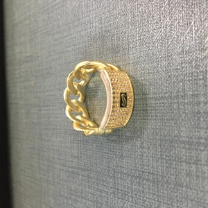 Close-up of a 14K gold-plated Cuban link ring featuring pavé zircons and S letter detail