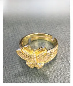 Detailed top view of gold butterfly ring with white cubic zirconia pavé and adjustable band