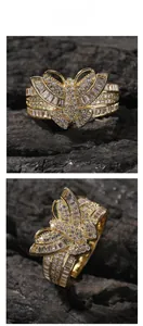 Macro detail of gold butterfly ring featuring cubic zirconia stones on textured background