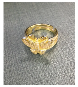 Close-up of golden butterfly ring with sparkling cubic zirconia on adjustable band