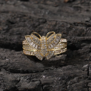 Luxury 3D butterfly ring in gold finish with sparkling cubic zirconia on a dark stone