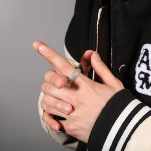 Dettaglio macro di anello hip-hop da uomo con pavé di zirconi cubici su tutta la fascia