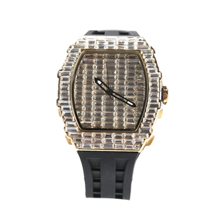 Macro shot of luxury gold watch dial with full diamond inlay and black silicone strap