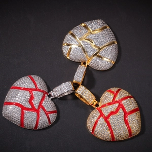 Detailed close-up of broken heart pendants with pave-set cubic zirconia in multiple colors