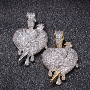 Macro shot of iced-out heart pendant with number two and lightning bolt detail
