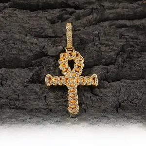 Macro shot of hip hop Ankh cross pendant crafted in gold copper with cubic zirconia stones