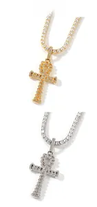 Detailed view of Ankh cross pendants in gold and silver with tennis chain and zircon stones