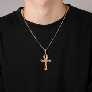 Hip hop gold Ankh cross pendant necklace with sparkling zircons on a male model