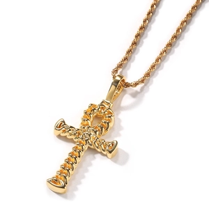 Detailed macro of gold Ankh cross pendant with intricate twisted rope texture and chain