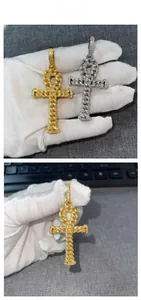 Detail of Ankh cross pendants with gold and silver finishes and pavé-set zircon stones