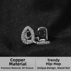 Detailed close-up of a silver-toned copper hip hop tooth grill with pavé cubic zirconia