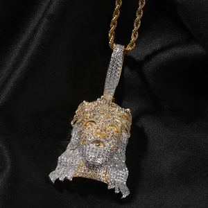 Macro detail of iced-out hip hop Jesus head pendant with cubic zirconia on gold rope chain
