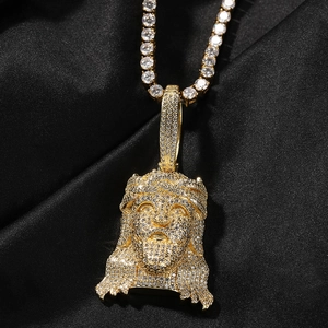 Close-up of hip hop Jesus head pendant with cubic zirconia on black silk background