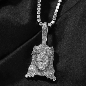 Detail of hip hop Jesus pendant with cubic zirconia stones on silver tennis chain