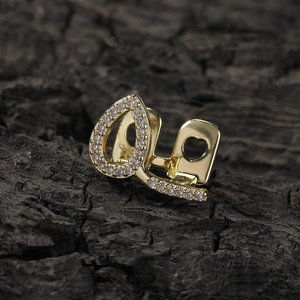 Macro shot of gold-plated hip hop grillz with heart cutout and micro-set cubic zirconia