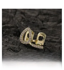 Macro shot of hip hop gold plated hollow heart grillz with iced out zircon stones